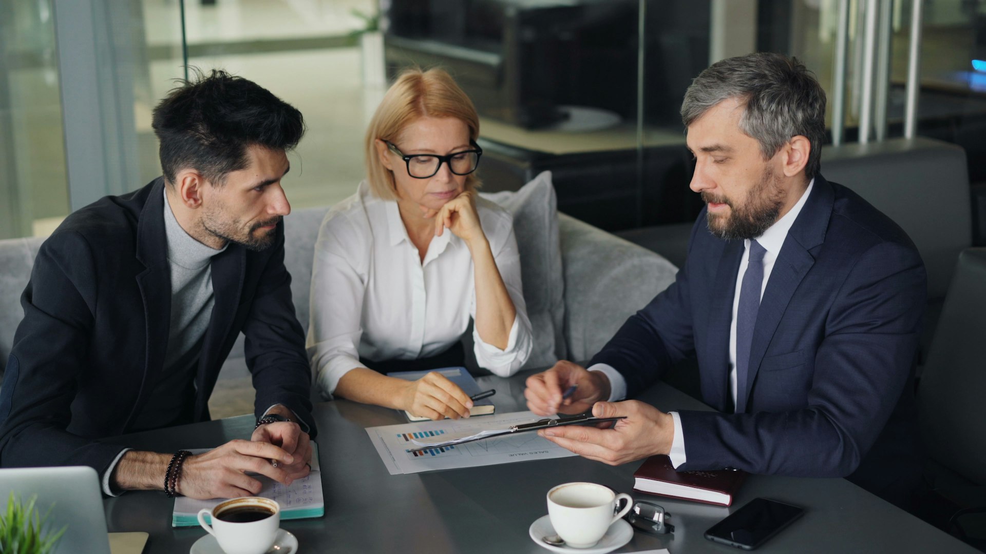 AI Strategy Playbook | Optimize AI Implementation for Business Growth AI Strategy Playbook – A guide to effective AI adoption and implementation for business successa group of people sitting around a table
